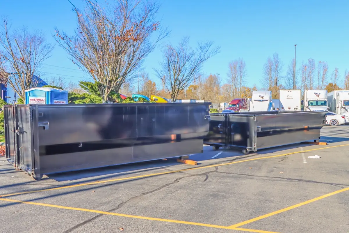 Professional dumpster rental service with roll-off container on residential driveway in Olney